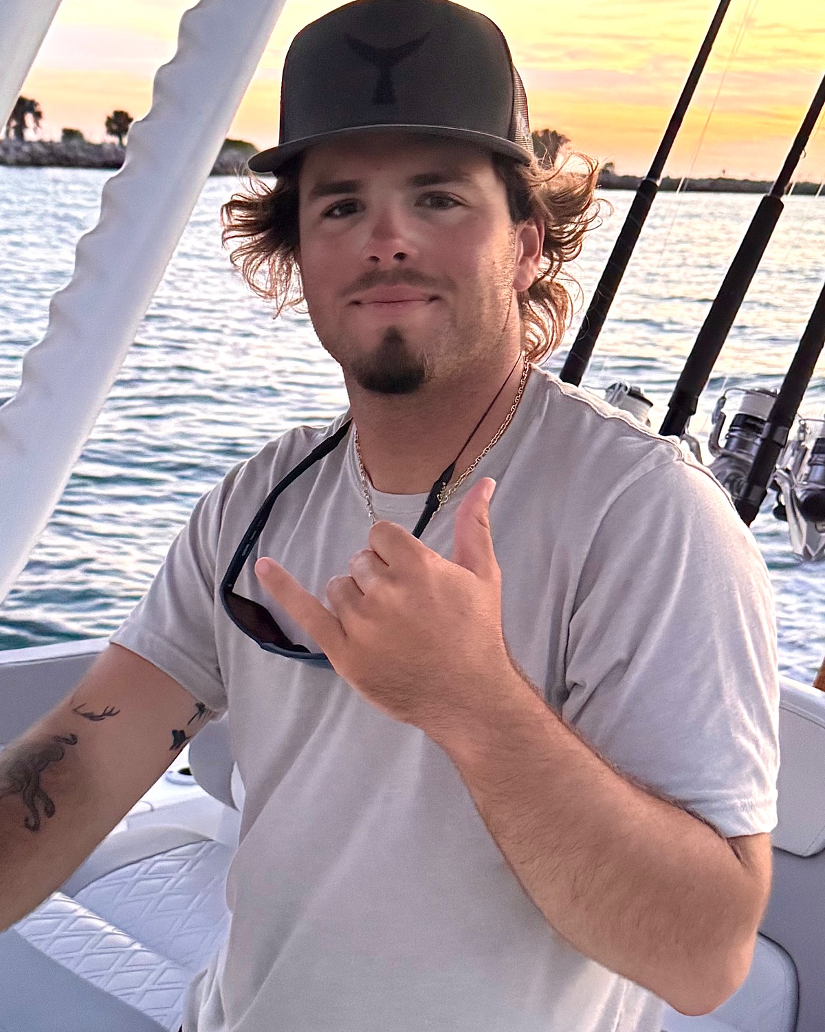 Capt. Bryce Artze at the helm of his 28' Caymas at sunset